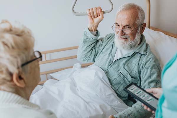 senior-patient-gets-up-from-the-hospital-bed-by-he-2022-02-02-04-48-54-utc