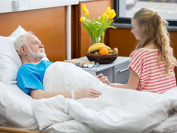 senior-patient-in-hospital-bed-with-granddaughter-2023-02-03-03-24-28-utc